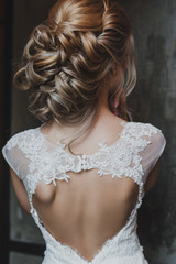 bride in vintage interior alone. Curly blonde hair. Back