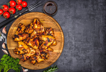 Grilled or oven roasted chicken wings glazed with barbecue sauce