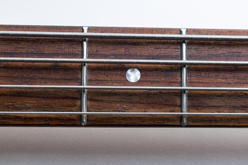 Frets on bass guitar. Close up. Vintage old retro bass in studio