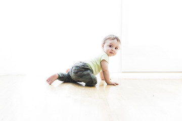 baby crawling on the floor with white background