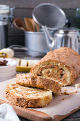 Homemade sweet biscuit roll with cream on wooden background