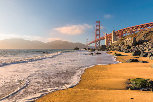 Golden Gate Bridge at sunset seen from the  beach in San Francisco, California. 