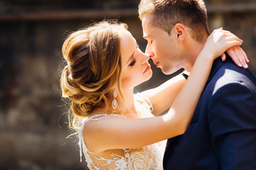 delicate bride wants to kiss her groom with closed eyes