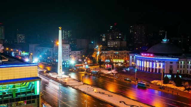 Kiyiv, Ukraine. A video of night city in Kiyiv, Ukraine, with city lights and traffic. Aerial view of Victory square. Time-lapse with traffic lights at night. Zoom in