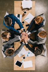 Fototapeta na wymiar overhead view of business partners at table in office, businesspeople teamwork collaboration relation concept
