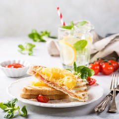 Hot fresh hawaii toast sandwich with ham, pineapple, tomato and cheese. Healthy summer food concept with copy space.