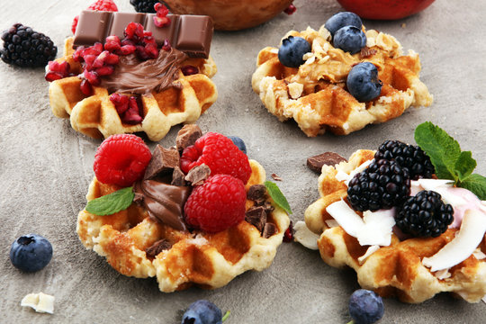 Belgian waffles with pomegranate and raspberries, homemade healthy breakfast with mint