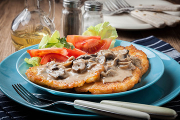 Crispy fried homemade potato pancakes with mushroom sauce.