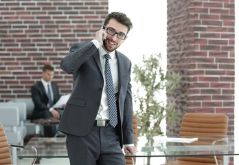 businessman talking on smartphone in his office