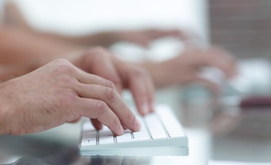 close-up of hand typing text on computer keyboard.