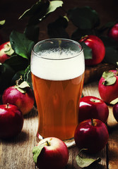 Apple cider in a large beer glass, vintage wooden background, rustic style, selective focus