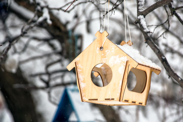 Winter bird feeder in the forest with snow