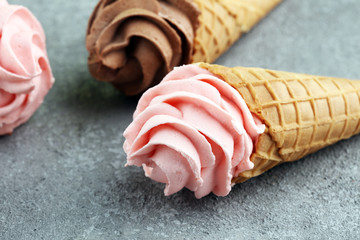 Vanilla frozen yogurt or soft ice cream in waffle cone.
