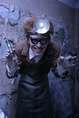 Portrait of a mad scientist with a syringe and a bulb. Halloween concept