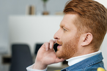 Handsome bearded man talking on phone