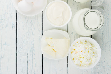 Different dairy products on the white wooden background