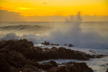 The blue waters of the Atlantic Ocean flowing into rocky cove off the coast of Tenerife.rocky coast of Canary Islands.  sunset on the Atlantic Ocean