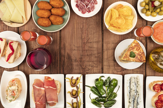 The food of Spain. Overhead photo of many different Spanish tapas with wine and copy space