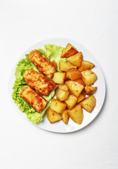 Fish and chips on a plate, white background, top view