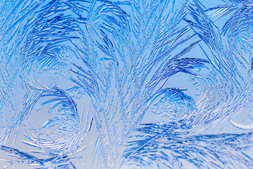 Blue drawings on the glass in the frost