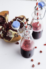 pomegranate juice in bottles with straws.