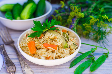 basmati rice with vegetables and parsley on wooden table