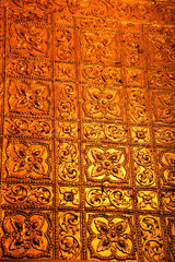 Close up of a golden wall designed with flowers inside the Buddhist Botataung pagoda, Yangon, Myanmar.