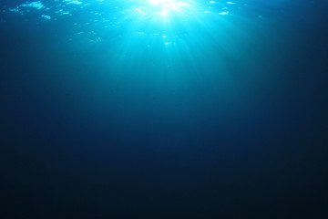 Underwater background. Sunlight on ocean surface