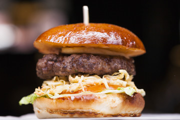 Tasty grilled prawn and beef burger with lettuce