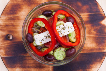 Greek salad is served with large pieces of cheese and vegetables