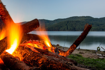 Slowly burning fire at lake shore