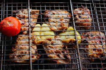 Meat on the grill with vegetables