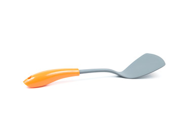 Grey plastic kitchen spatula with orange handle isolated on white background, surface. Kitchen accessory.