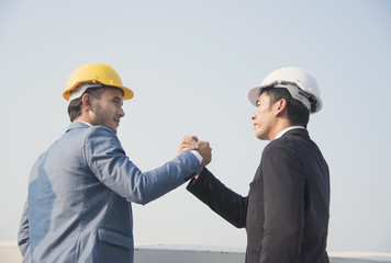 Business partner handshake between a business and engineer join new project.Teamwork group unity as businesspeople.