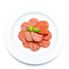 Italian Salami or spanish chorizo on plate white background