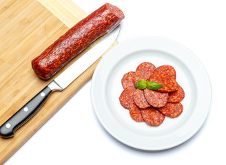 Italian Salami or spanish chorizo on plate white background