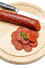 Italian Salami or spanish chorizo on plate white background