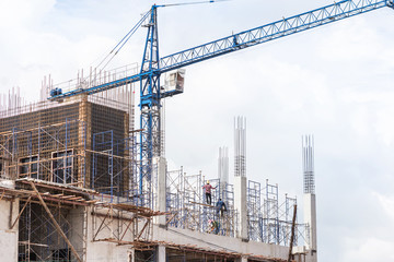 Fototapeta na wymiar big blue cranes in building construction site on blue sky background