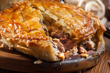 Fresh beef stew pie on a cutting board