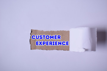 A businessman shows an inscription:CUSTOMER EXPERIENCE