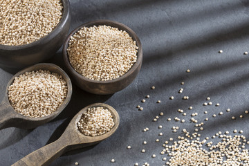 Organic quinoa seeds in the bowl and spoon