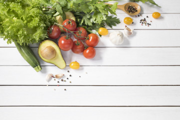 Selective focus variety of vegetables on white wooden background top view and copy space.