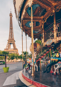 Carousel and Eiffel tower on background in Paris, France.