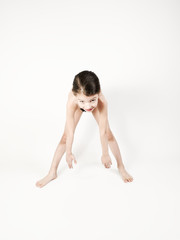 Naklejka premium Nice barefoot boy in sport outfit stretching back muscles, looking relaxed