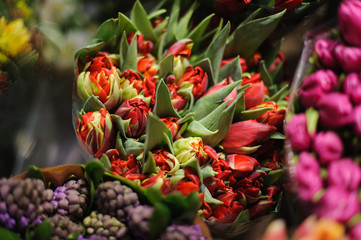 Wonderful bouquet of red tulips decorated with green leaves © fesenko