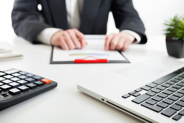 Close up view of bookkeeper or financial inspector hands making report, calculating or checking balance. Marketing strategy brainstorming. Paperwork and digital in office.