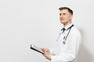 Confident experienced handsome young doctor man isolated on white background. Male doctor in medical uniform, stethoscope holding tablet pc computer. Healthcare personnel, health, medicine concept.