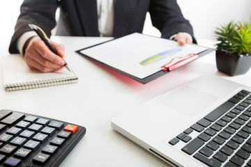 Close up view of bookkeeper or financial inspector hands making report, calculating or checking balance. Marketing strategy brainstorming. Paperwork and digital in office.