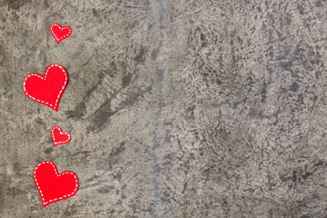 Obraz na płótnie Canvas Red hearts on gray concrete background. Copy space. Top view.
