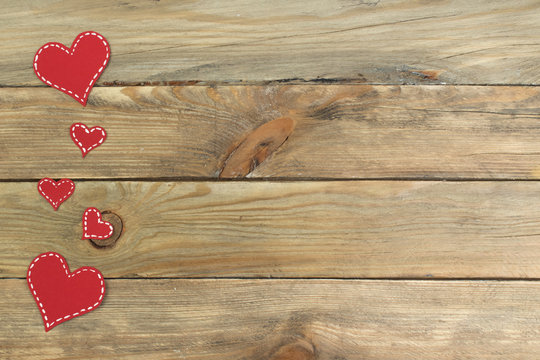 Red paper hearts on a wooden background. Valentine's Day. Copy space. Top view.